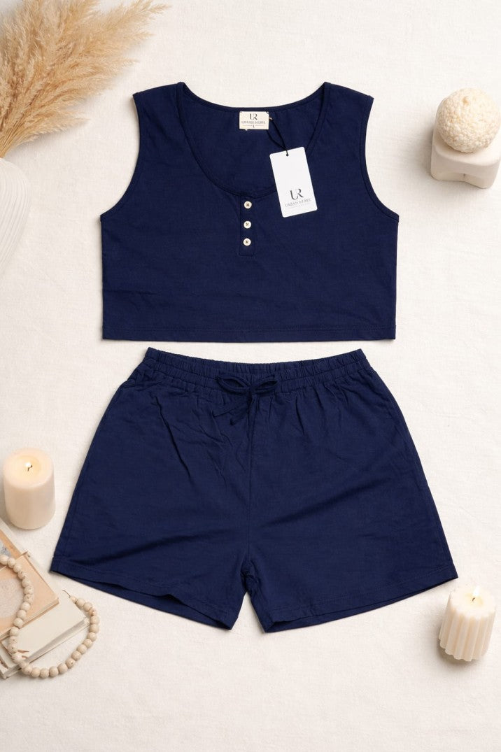 Navy blue sleeveless top and shorts set with a tag on a light background